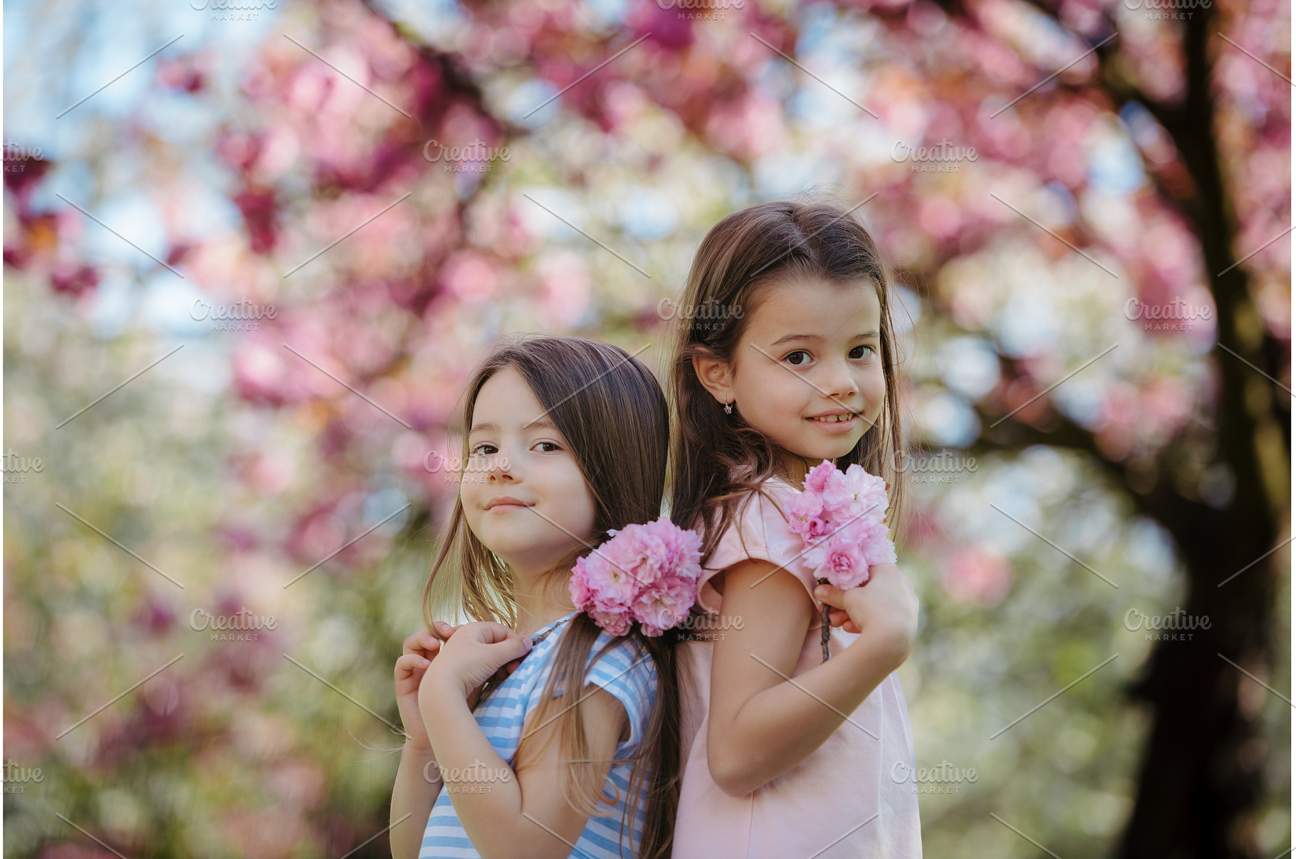 Sisters back to back in spring, a Person Photo by HalfPoint
