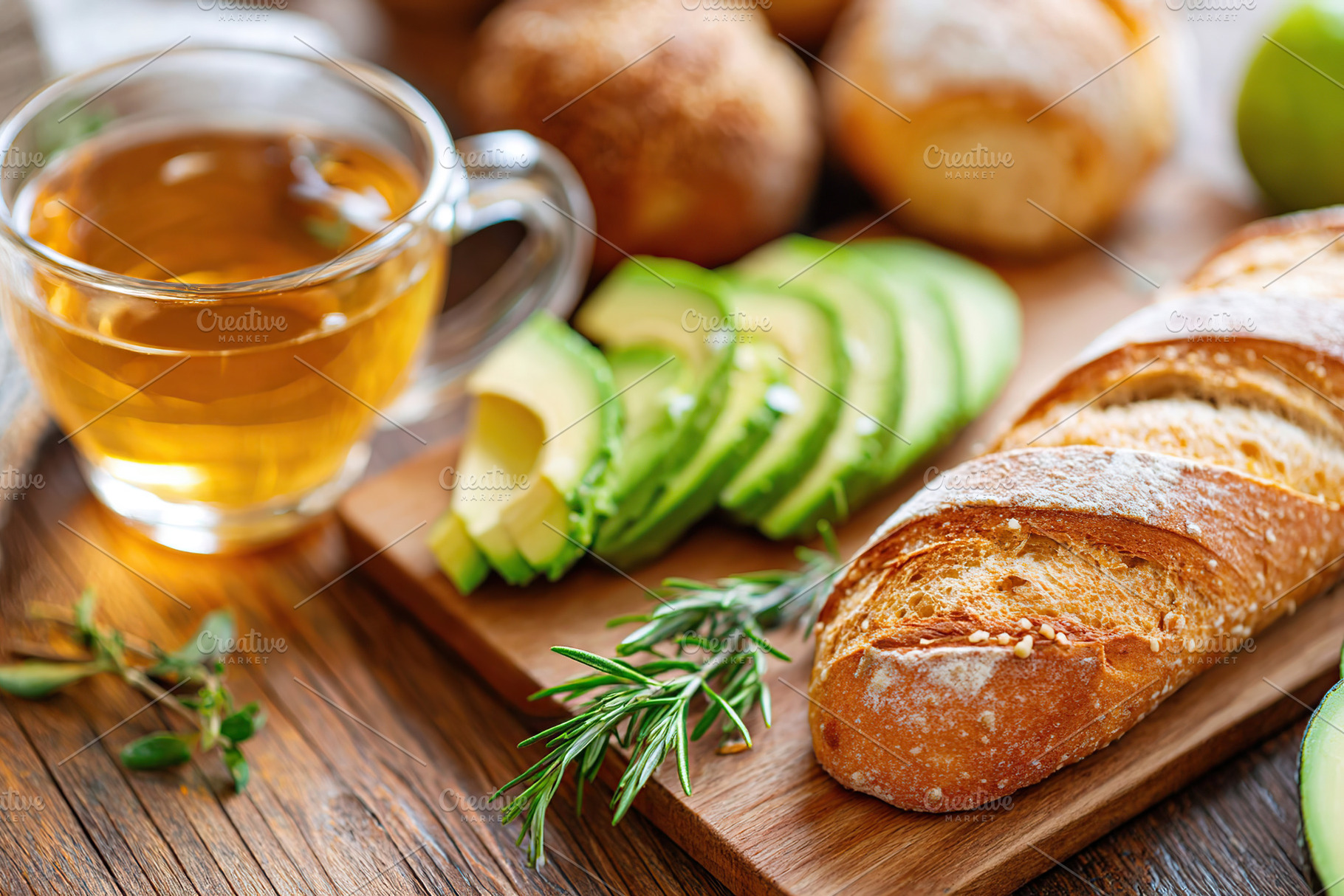 Sliced avocado and fresh bread served with herbal tea on a wooden table, a Food & Drink Photo by AlyaAnd