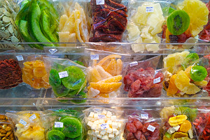 Colorful dried fruits at market stall, a Food & Drink Photo by DanFLCreativo