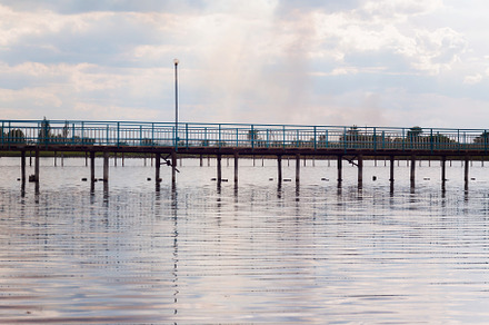 Wooden long bridge over a sea plait, river at sunset in perpekti, a Nature Photo by TanaCh