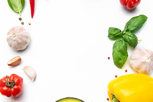 Fresh vegetables and spices creating a border, a Food & Drink Photo by Olena Rudo
