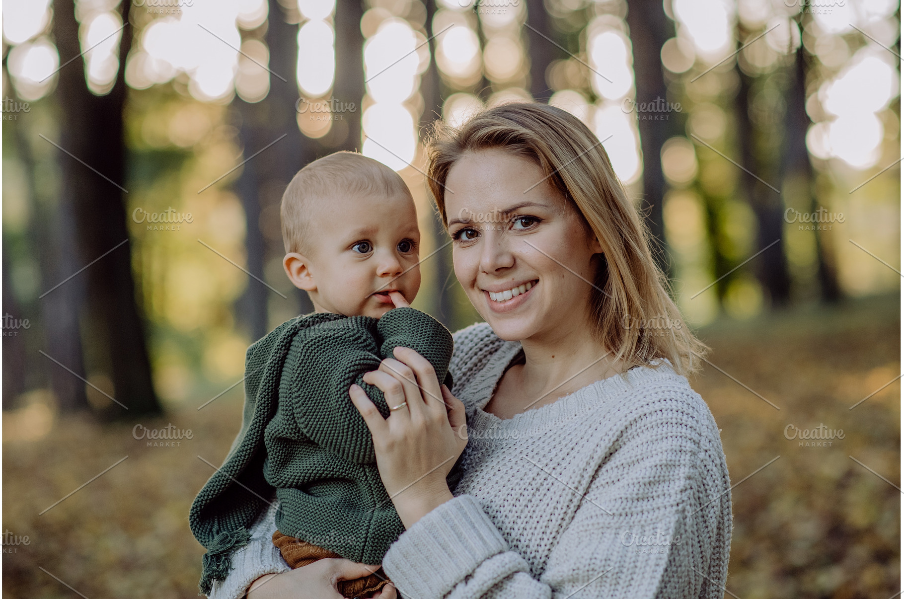 Mother holding her little baby son, a Nature Photo by HalfPoint