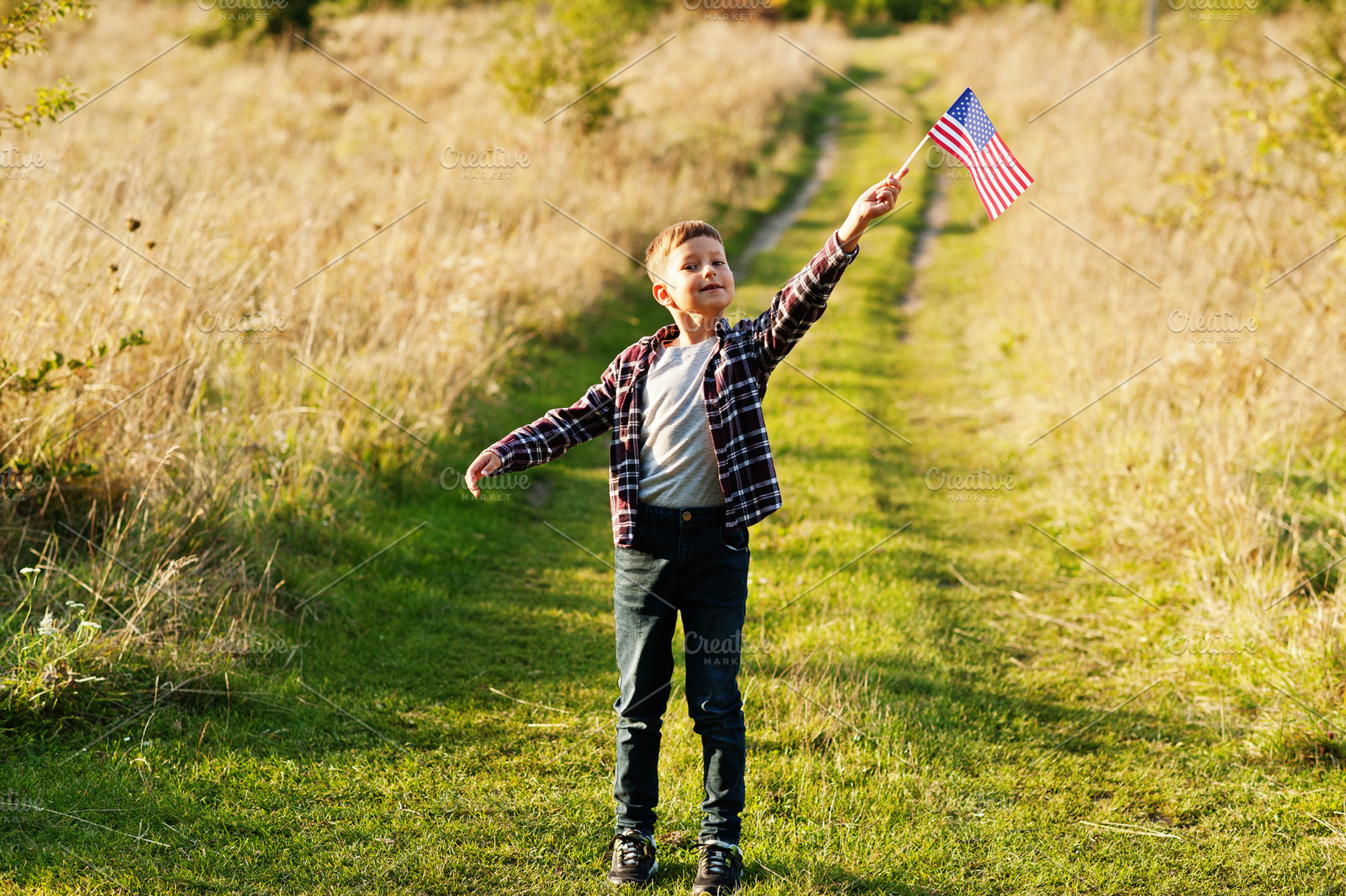 Little boy with USA flag outdoor. America celebrating., a Person Photo by AS photostudio