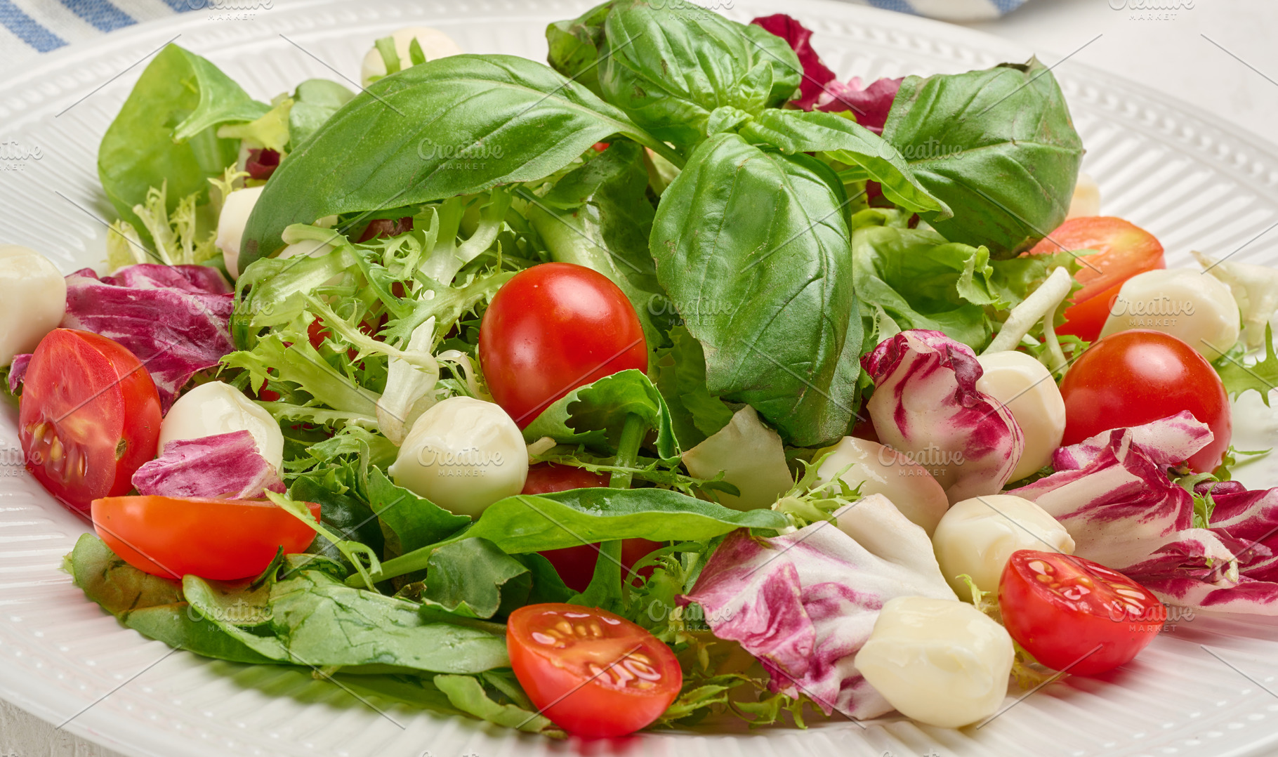 Fresh salad with mixed greens, radicchio and cherry tomatoes, a Food & Drink Photo by ndanko