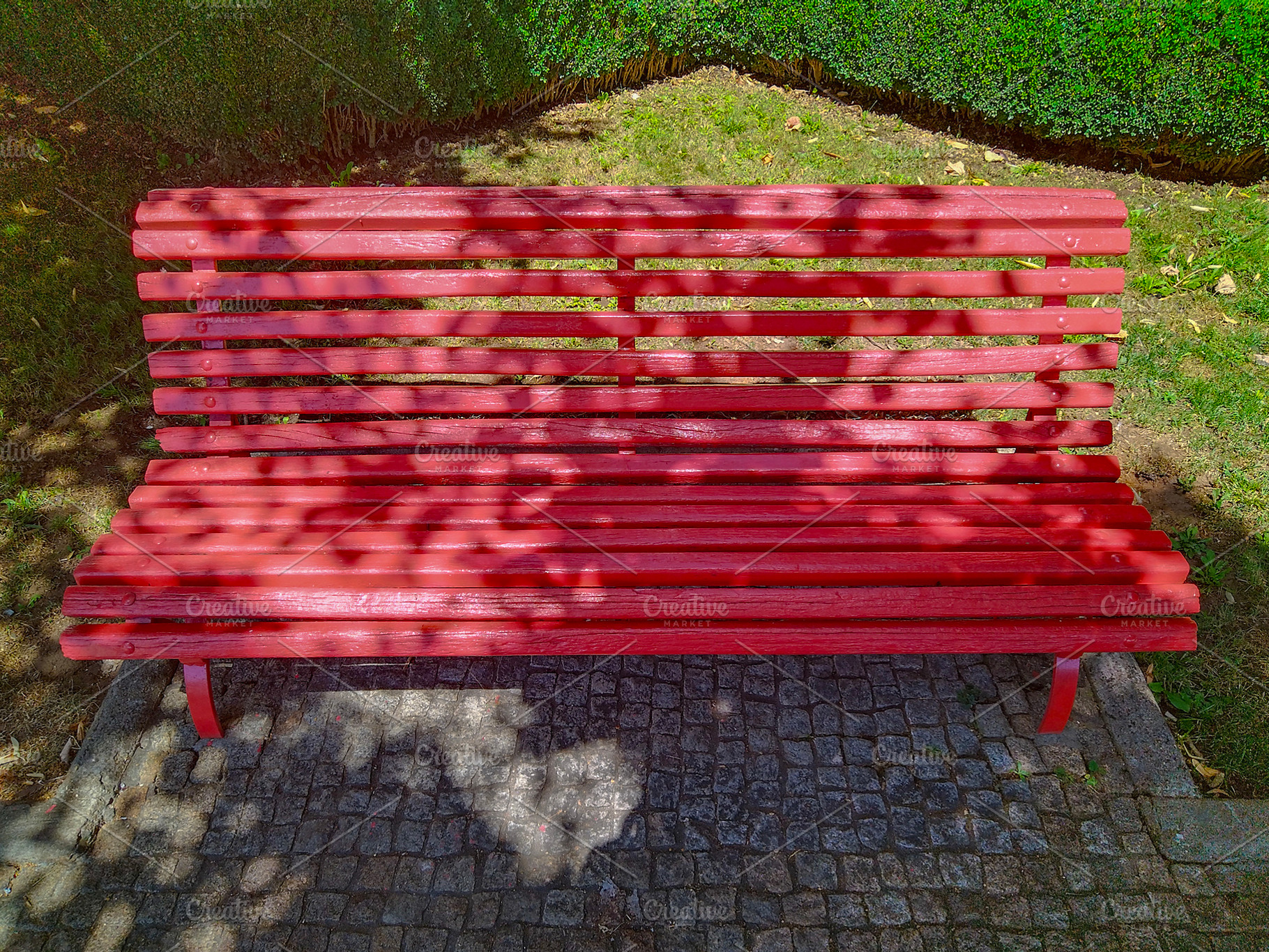 Red wooden bench in sunlit park, an Arts & Entertainment Photo by DanFLCreativo