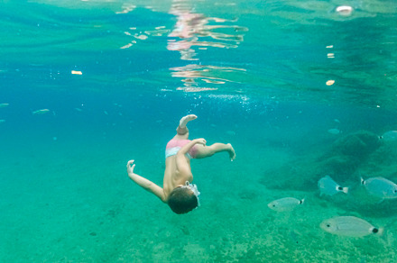 Little kid diving on the Mediterranean sea, a Person Photo by Cosca