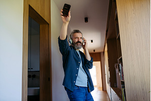 Bearded man dancing at home while, a Person Photo by HalfPoint