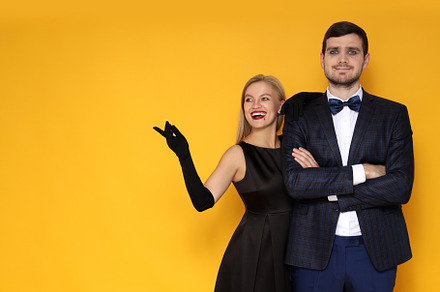 Concept of Halloween, young man and woman on yellow background, a Person Photo by AtlasStudio PRO