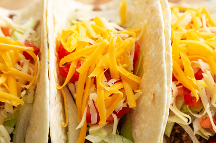 Homemade American Beef Tacos with lettuce, tomato and cheese on, a Food & Drink Photo by LiudmylaChuhunova