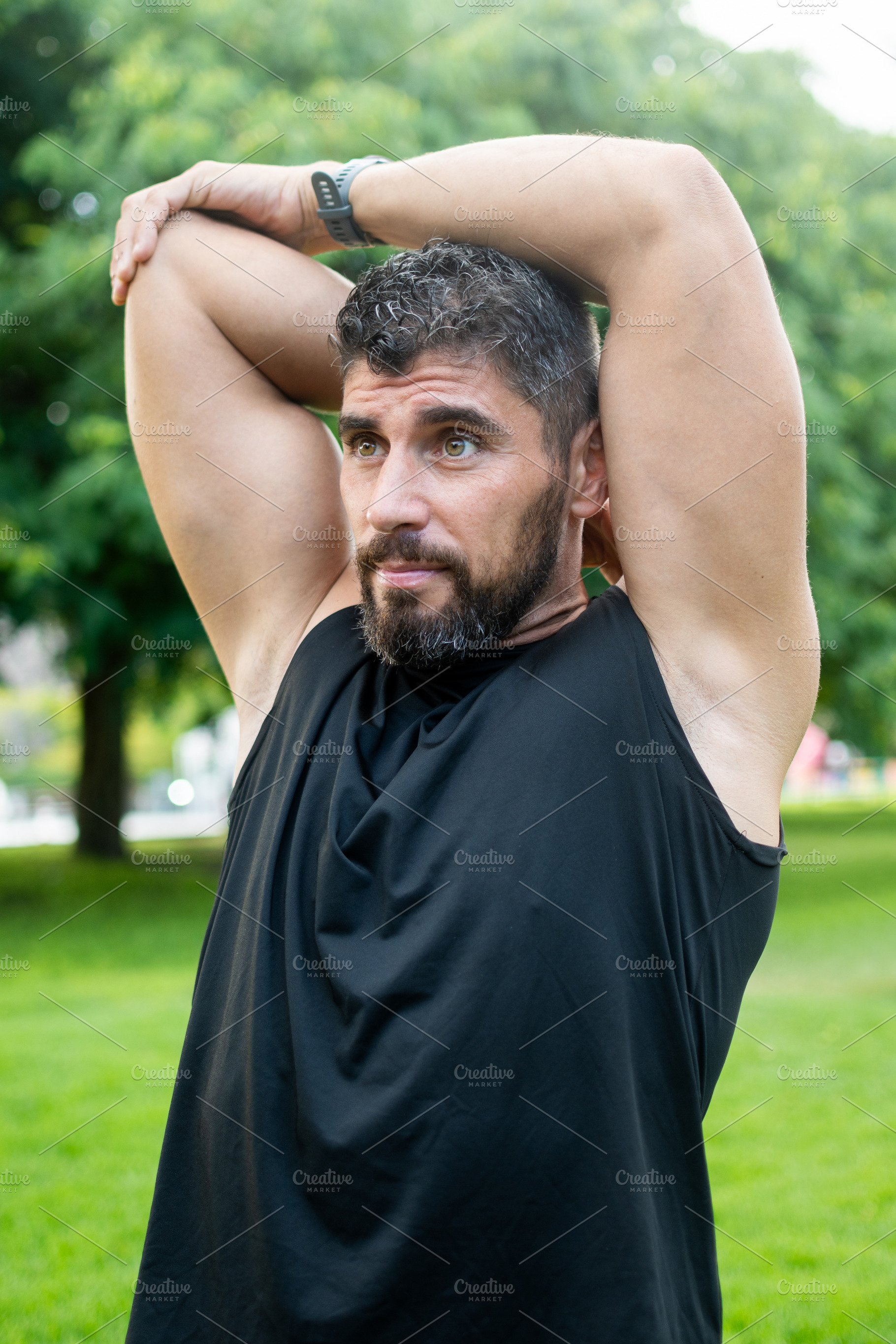Athletic Man Stretching Triceps Before an Outdoor Workout in a Park, a Sports & Recreation Photo by etorres69
