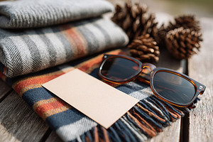 Elegant flat lay of vintage scarf and sunglasses with natural elements for a co, a Photo by AlyaAnd