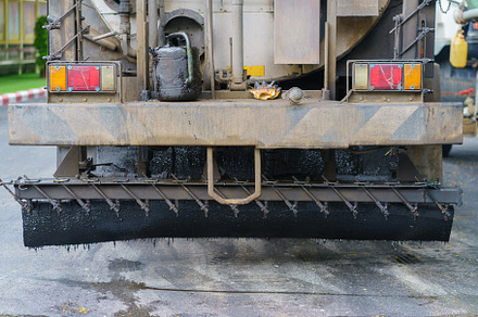 Asphalt paver machine during road work, Road Machinery at constr, an Industrial Photo by Casanowe-studio