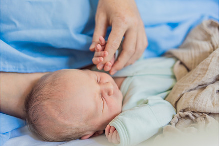 A baby lies with the mother after