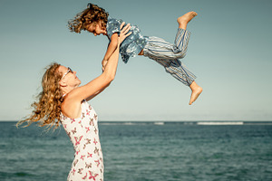 Mother and  son playing on the beach stock photo containing family and, a Person Photo by altanaka