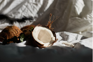 Fresh coconuts on a white cloth with, a Food & Drink Photo by IlliaBondarPhotography