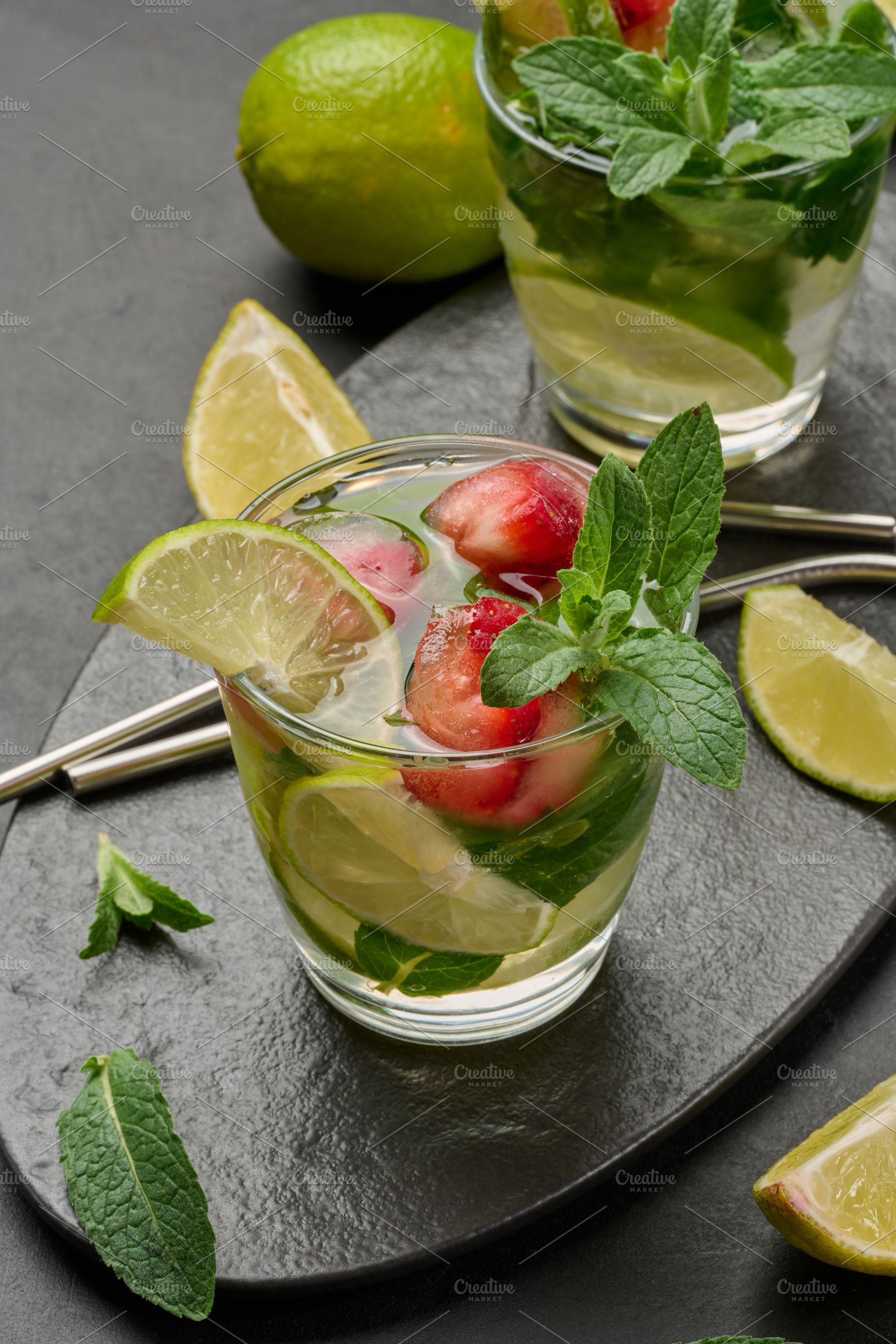 Refreshing mojito cocktail with lime, mint, strawberry, and ice, a Food & Drink Photo by ndanko