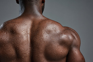 Muscular man with wet back in studio, a Photo by Beautiful things