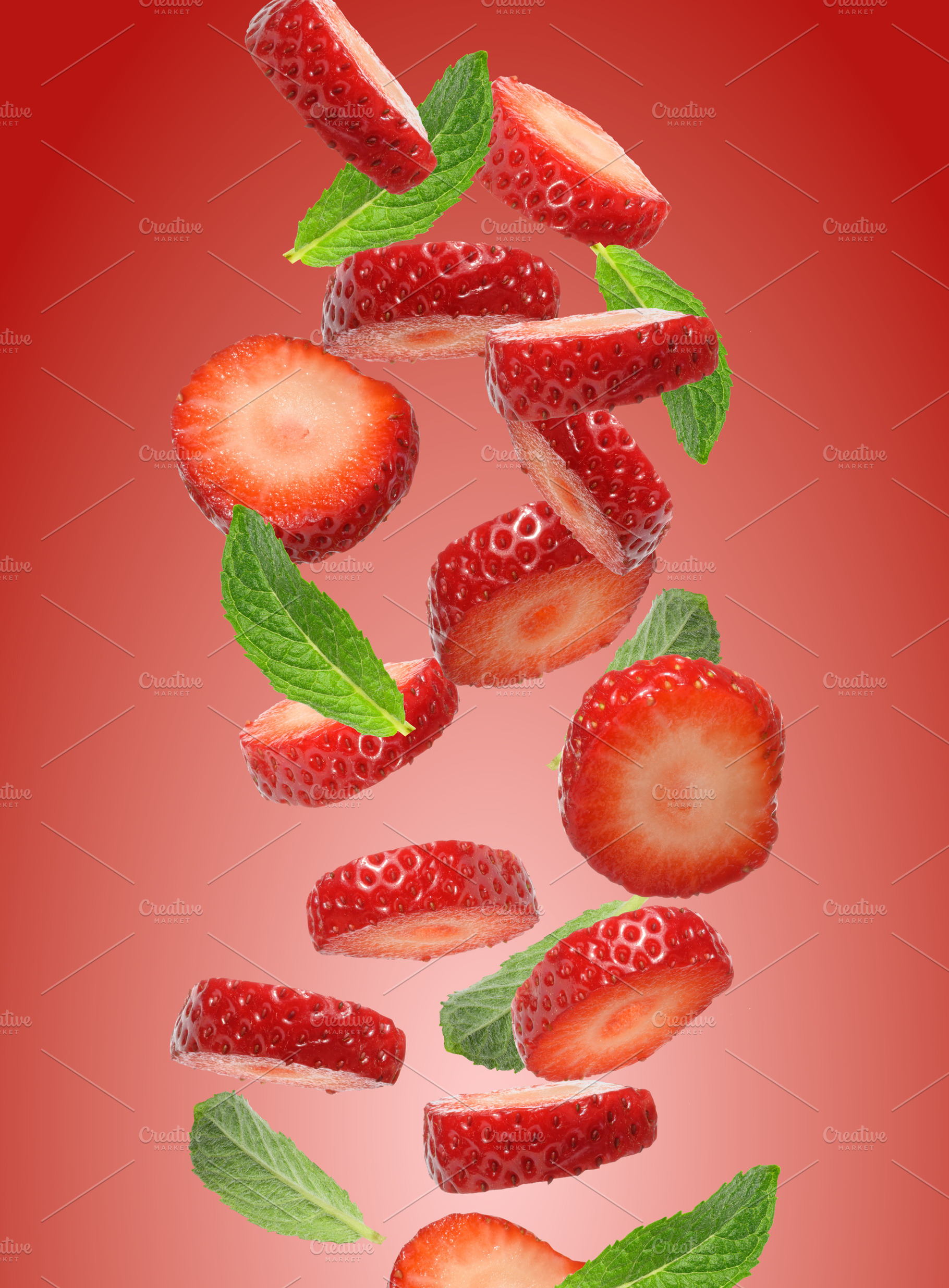 Lots of strawberry pieces and mint leaves flying on red gradient, a Food & Drink Photo by ndanko