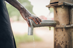 African Child's Hand on Water Spout