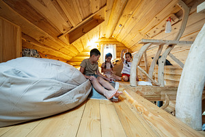 Wooden loft interior with children playing and relaxing, a Photo by AS photostudio
