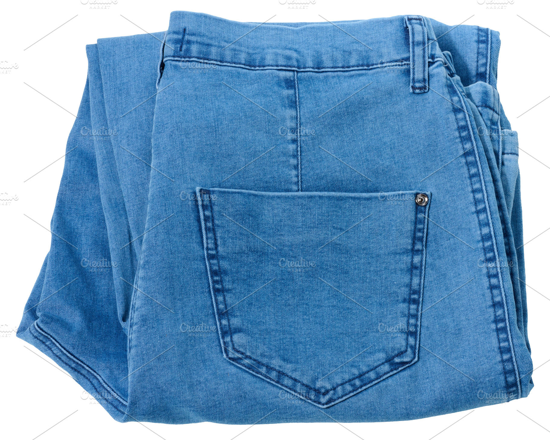 Folded pair of light blue denim jeans with visible back pocket,, a Beauty & Fashion Photo by ndanko