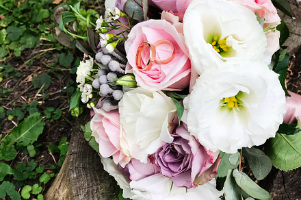 Elegant wedding bouquet with roses on rustic tree stump outdoors, a Photo by AS photostudio