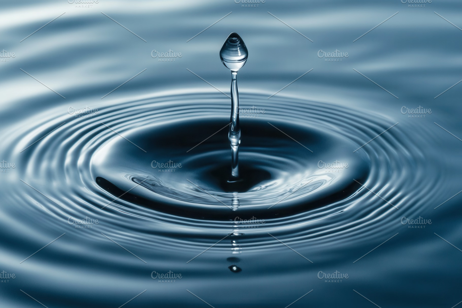 Droplet creates ripples of calm, a Photo by Pavel_design