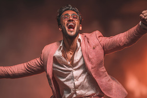 Ecstatic young man celebrating wearing stylish outfit in vibrant lighting setti, a Person Photo by AS photostudio