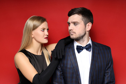 Concept of Halloween, young man and woman on red background, a Person Photo by AtlasStudio PRO