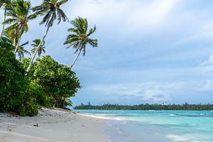 Anini Marae Beach on Huahine, French Polynesia, with turquoise w, a Photo by GoodGoods