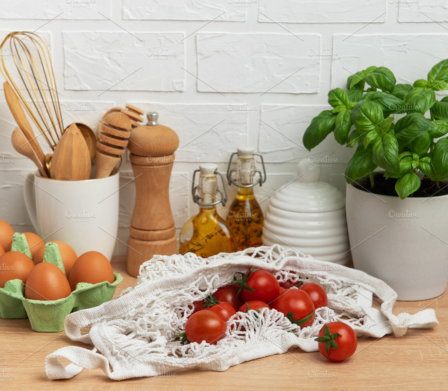 Cherry tomatoes, basil and eggs resting on kitchen counter, embo, a Food & Drink Photo by Olena Rudo