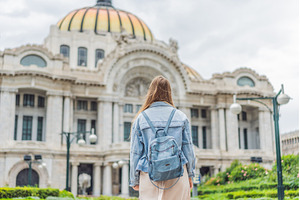 Woman tourist standing in front of, an Architecture Photo by Elizaveta Galitskaya