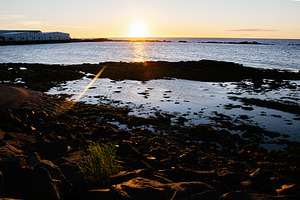 Sunset over a rocky shoreline and calm waters in scenic Iceland, a Nature Photo by AS photostudio