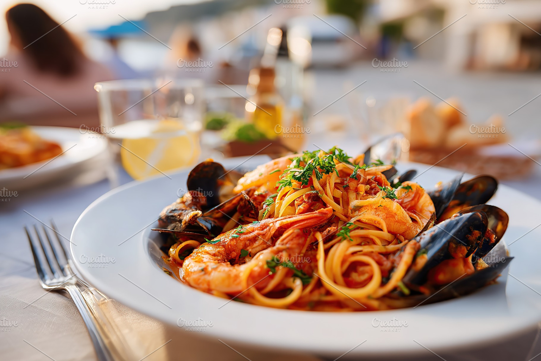 Enjoying linguine pasta with tomato sauce at a seafood restaurant by the coast, a Food & Drink Photo by AlyaAnd