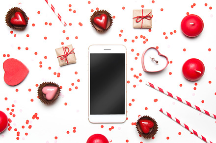 Flatlay with confetti heart & phone featuring anniversary, ad, and birthday, a Holiday Photo by KateAedon
