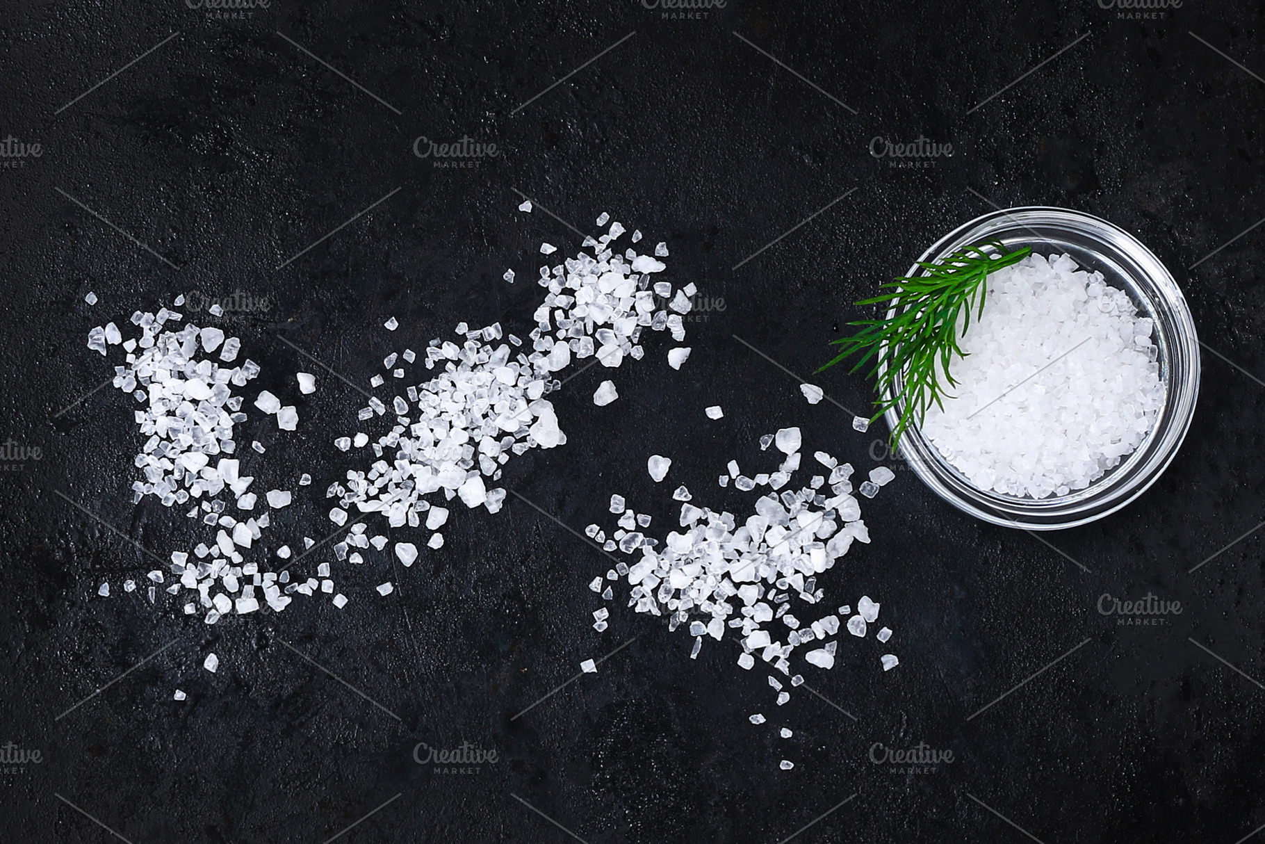 Coarse salt crystals on black table. Bowl with sea salt. Background for adverti, a Food & Drink Photo by Detriana