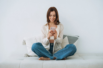 Young woman with mobile at home, a Person Photo by Galina_Zhigalova