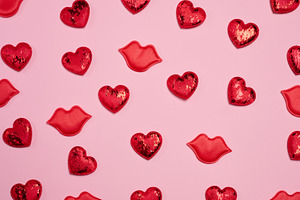 Pattern of red glitter hearts and lip appliqués randomly placed, a Holiday Photo by ndanko