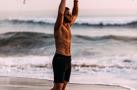 A sporty man with a surfboard, a Person Photo by SOTNIKOV_MISHA