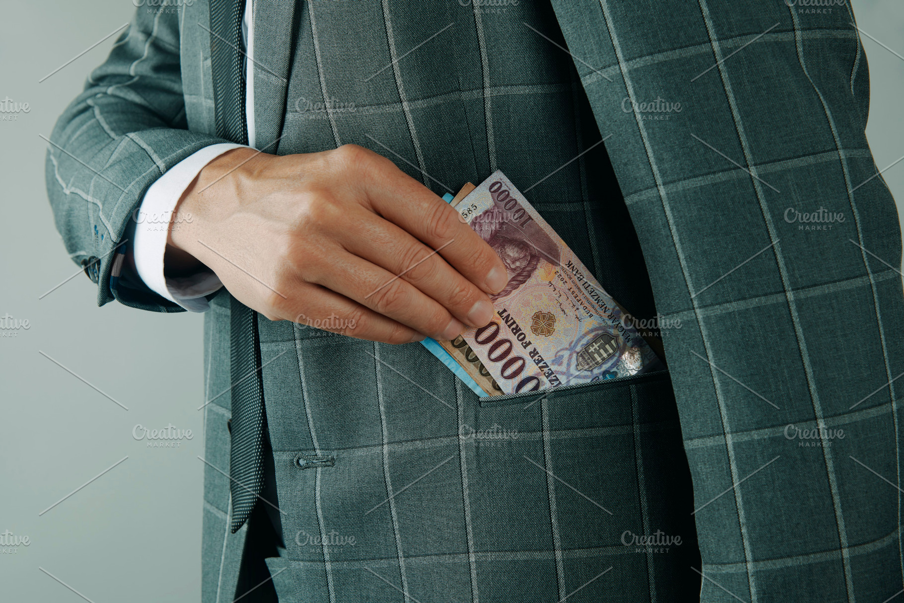 man putting Hungarian forints in pocket, a Photo by Nito