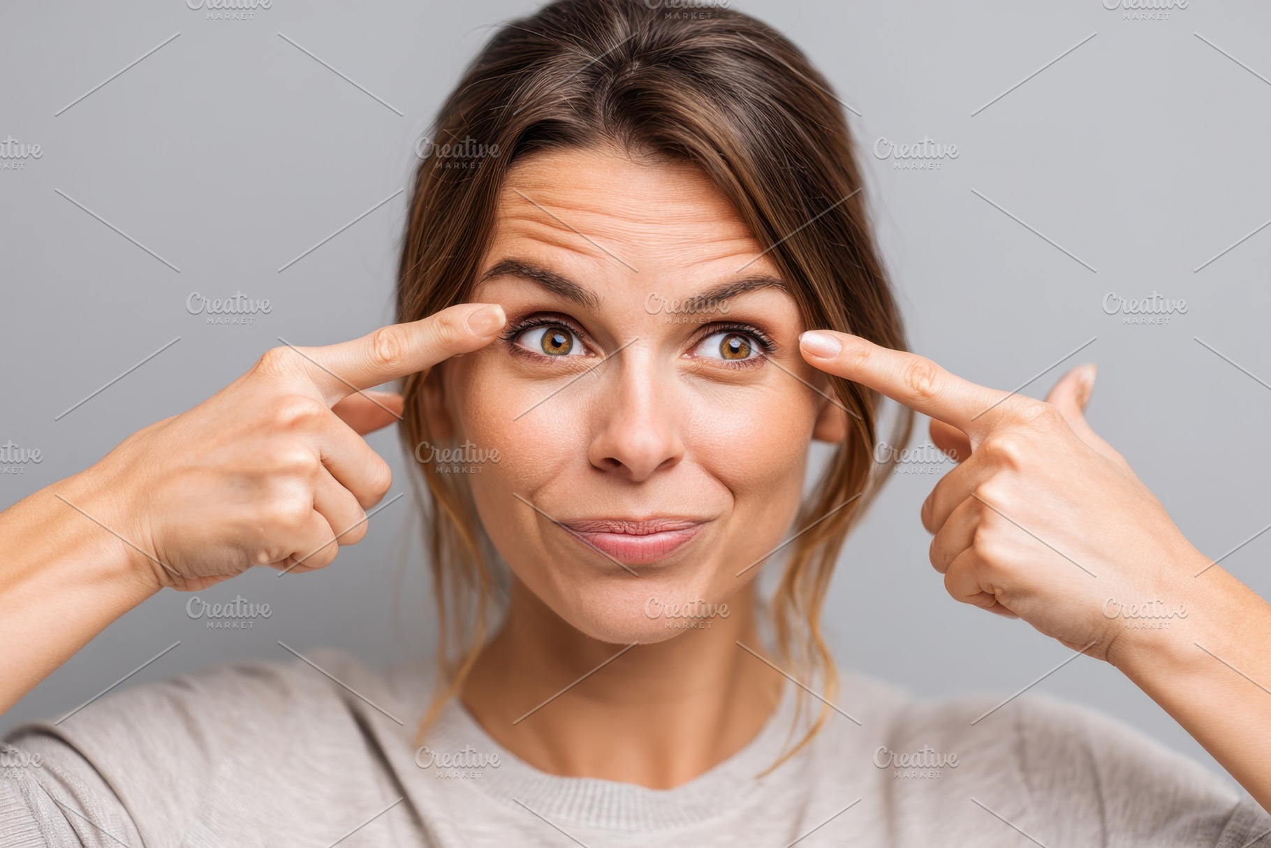 Thoughtful young woman pointing to her forehead, a Person Photo by AlyaAnd