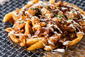 Loaded french fries with chicken, caramelized onion and sauce served on glass p, a Food & Drink Photo by etorres69