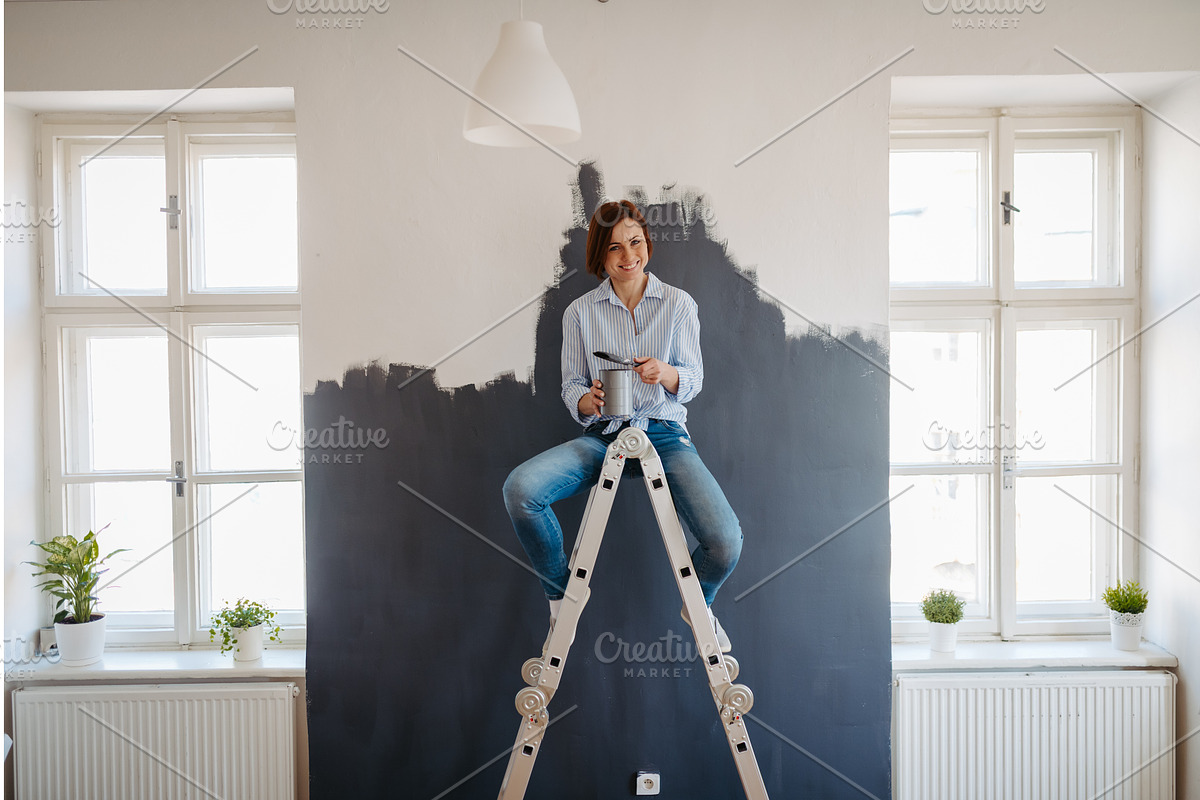 Beautiful woman painting walls of, a Graphic by HalfPoint