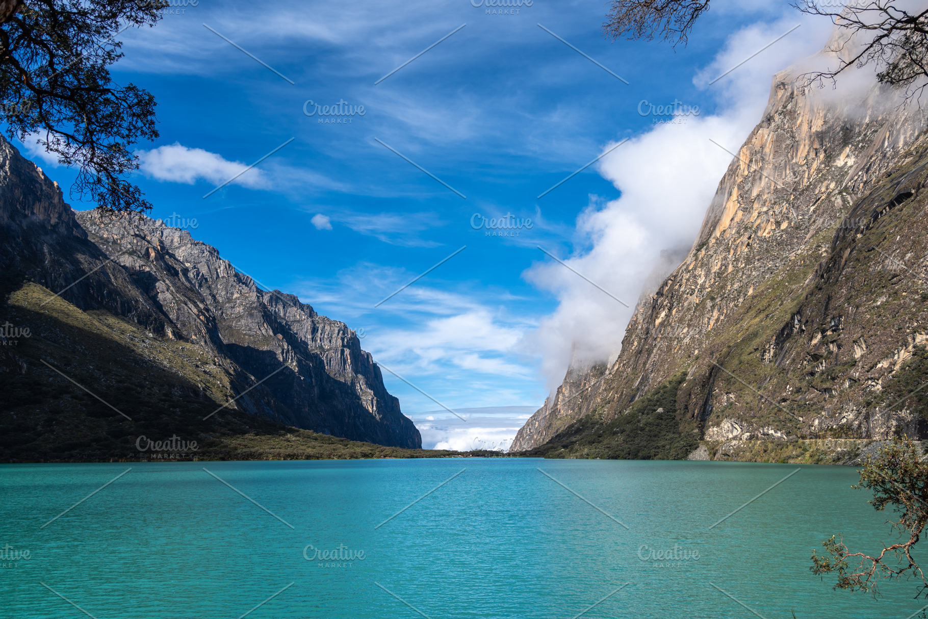 Turquoise lake surrounded by mountains on the Laguna 69 trek, Pe, a Photo by GoodGoods