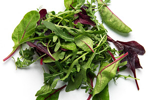 Fresh organic mixed greens salad pile on white background, a Food & Drink Photo by Olena Rudo