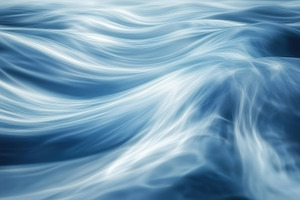 A close-up view of flowing water, showcasing smooth, wavy patterns in shades of, a Photo by Textures & Backgrounds