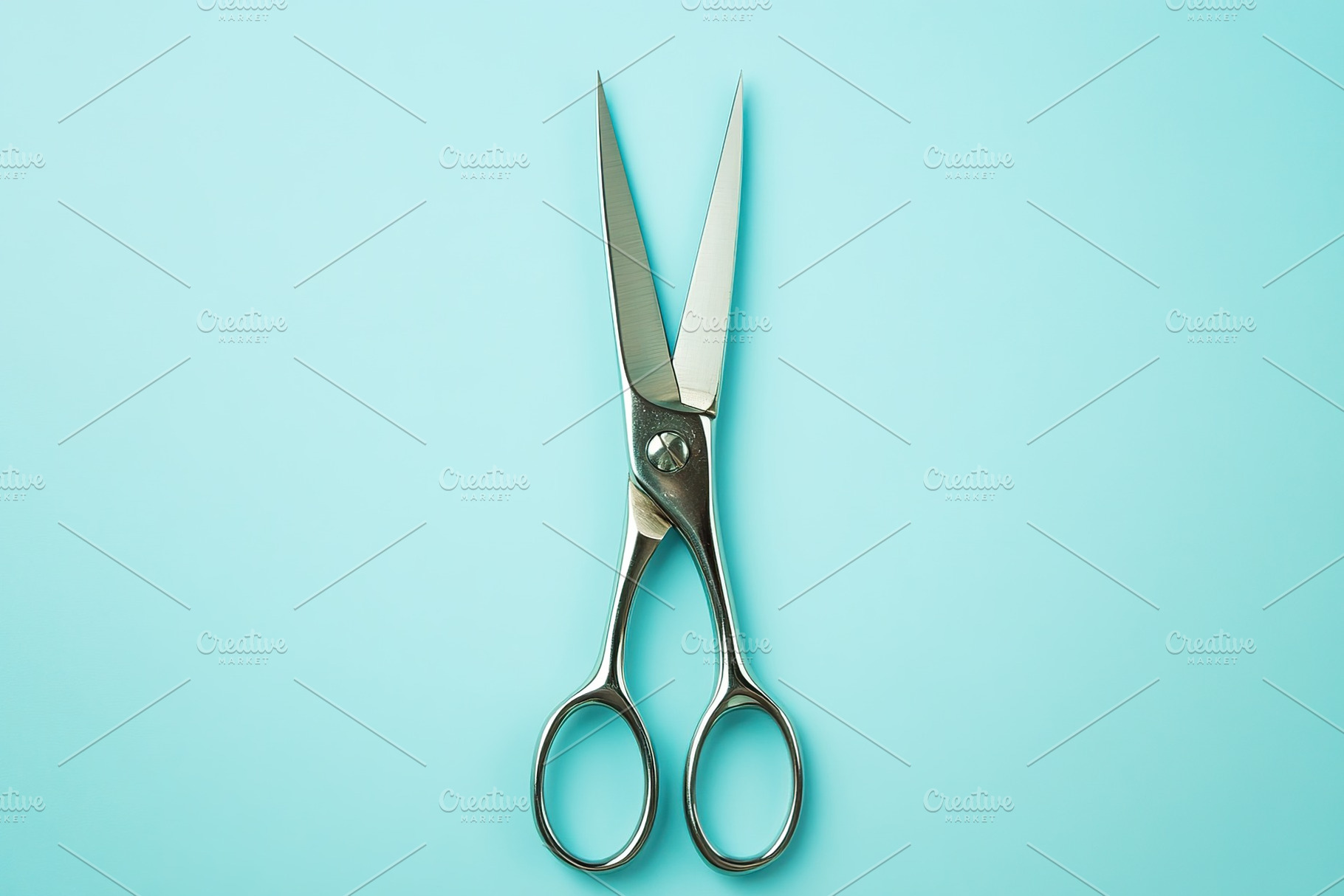 Sterile surgical scissors on blue background, a Photo by AlyaAnd