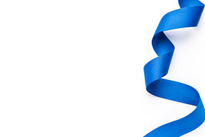 Blue ribbon curling on white background for celebtation, a Photo by Olena Rudo