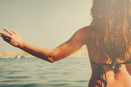 Young girl having fun in the sea, a Person Photo by hitdelight