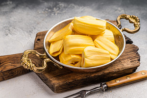 Sweet, golden jackfruit pods (bulbs) in a traditional metal bowl, a Photo by composter-box@mail.ru